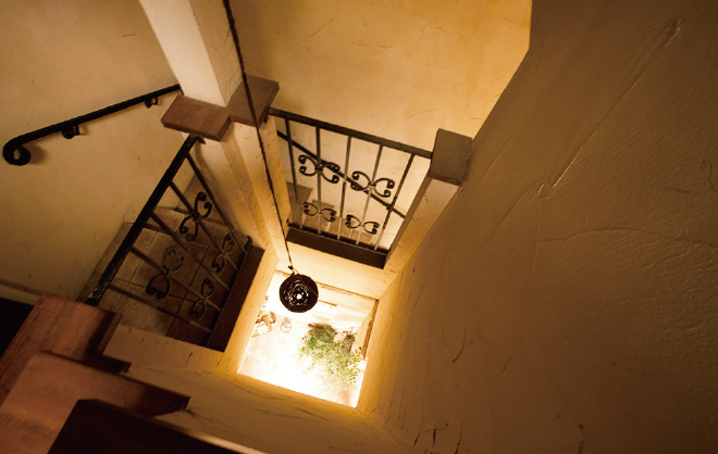 2階の住居へと続く螺旋階段。連続するロートアイアンの階段手摺りが、まるでパリのアパルトマンのよう。最上階の塔屋は、景観を考慮した洗濯物干場に